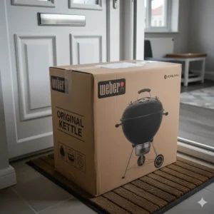 The retail packaging of a Weber Original Kettle charcoal BBQ as delivered by a UK retailer, ready for assembly.