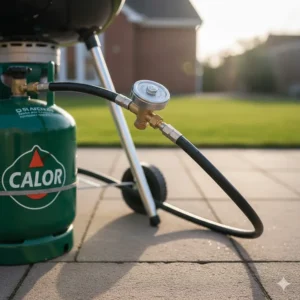 A Weber Q BBQ connected to a standard UK patio gas cylinder using a regulator.