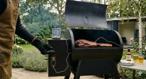 Close-up of a digital meat thermometer probe inside a smoker, ensuring precise temperature control in British weather.
