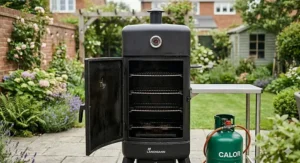 View inside a wide-body propane smoker showing four adjustable chrome-plated smoking racks for meat and fish.