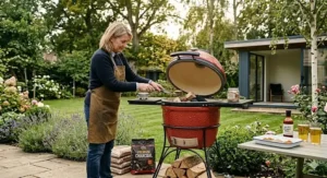 A red ceramic kamado-style charcoal barbecue and smoker suited for British outdoor kitchens.