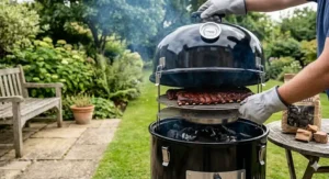 A traditional black offset barrel smoker producing blue smoke, ideal for cooking authentic pork ribs.