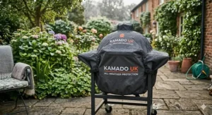 Alt text for image 9: A budget kamado grill protected by a heavy-duty waterproof cover with Kamado UK branding during a frosty British winter day.