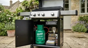 A 3 burner gas BBQ featuring an enclosed storage cabinet for a 5kg Patio Gas green cylinder.