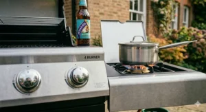 Detailed shot of the integrated temperature gauge on the hood of a heavy duty 4 burner gas bbq for precise roasting control.