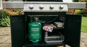 A clean, removable grease drip tray sliding out from underneath a heavy duty 4 burner gas bbq for easy maintenance.