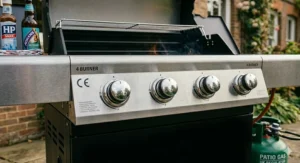 Close-up of the folding side table and integrated side burner on a heavy duty 4 burner gas bbq, ideal for preparing sauces outdoors.