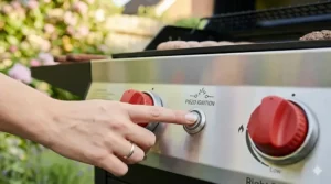 Illustration of the push-button piezo ignition system on a compact gas barbecue.