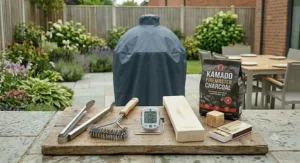 A selection of essential BBQ tools including long-handled tongs, a wire brush, and a digital meat thermometer.