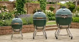 Two different sizes of ceramic barbecues standing side-by-side on a patio to help you choose the right model in our ceramic bbq reviews.