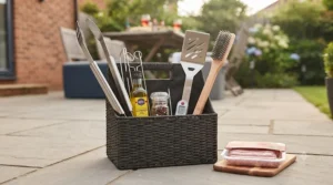 Essential barbecue tools including long-handled tongs, a spatula, and a wire brush.