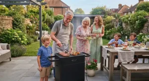 A family enjoying a summer meal cooked on an outdoor electric BBQ in the garden.