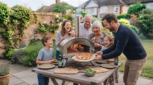 Family gathering outdoors in the UK enjoying homemade pizzas cooked in an affordable garden oven.