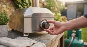 Close-up of a gas pizza oven control dial being turned on for instant ignition.
