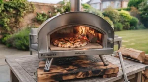 Lightweight wood-fired pizza oven set up on a wooden garden deck for summer entertaining.