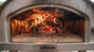 Internal view of roaring flames inside a budget-friendly wood-fired pizza oven reaching high temperatures.