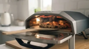 Using an indoor smokeless electric pizza oven safely inside a modern UK city flat kitchen.