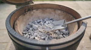 Minimal grey ash residue left behind by high-grade lumpwood charcoal after a long smoking session.