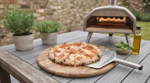 A freshly sliced homemade pizza featuring a crispy, charred crust achieved using a portable gas pizza oven.