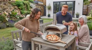 An outdoor electric pizza oven operating on a patio during a typical overcast British afternoon.
