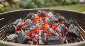 Glowing lumpwood charcoal showing high heat output for authentic grilling.